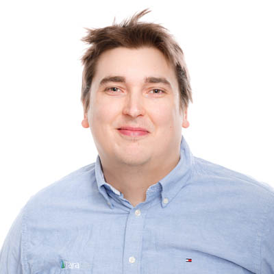 A man looks at the camera and smiles.