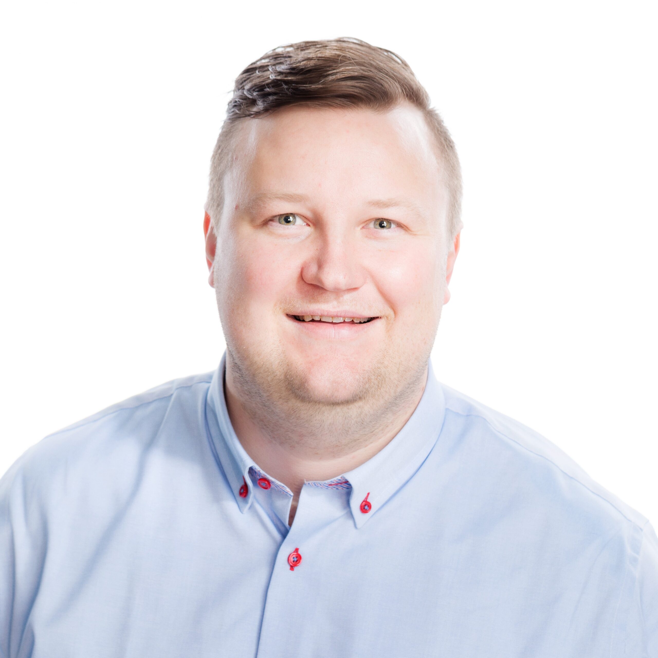 A man looks at the camera and smiles.