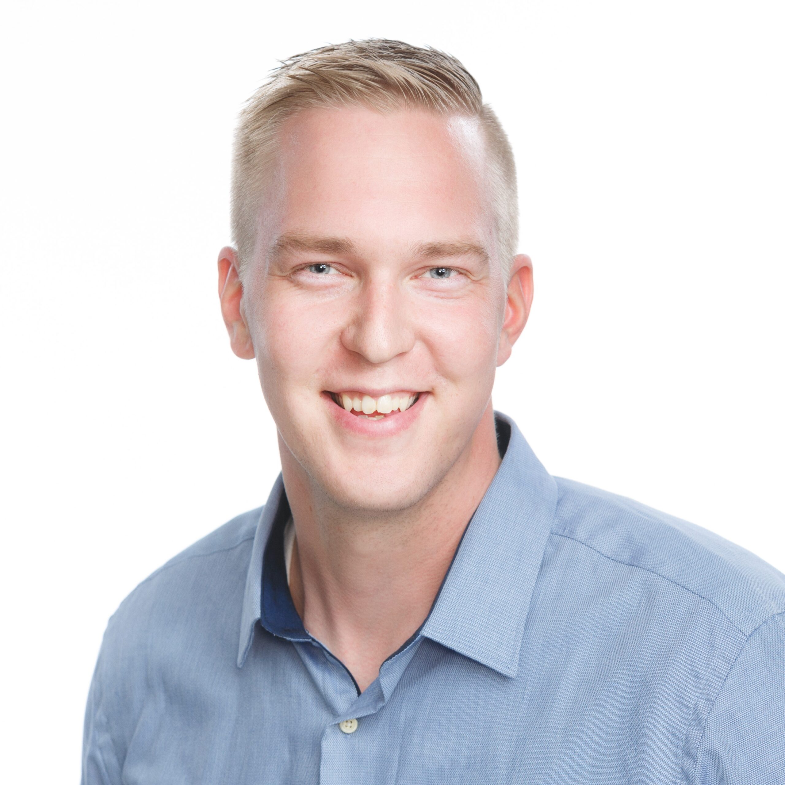 A man looks at the camera and smiles.