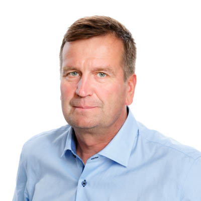 A man looks at the camera and smiles.