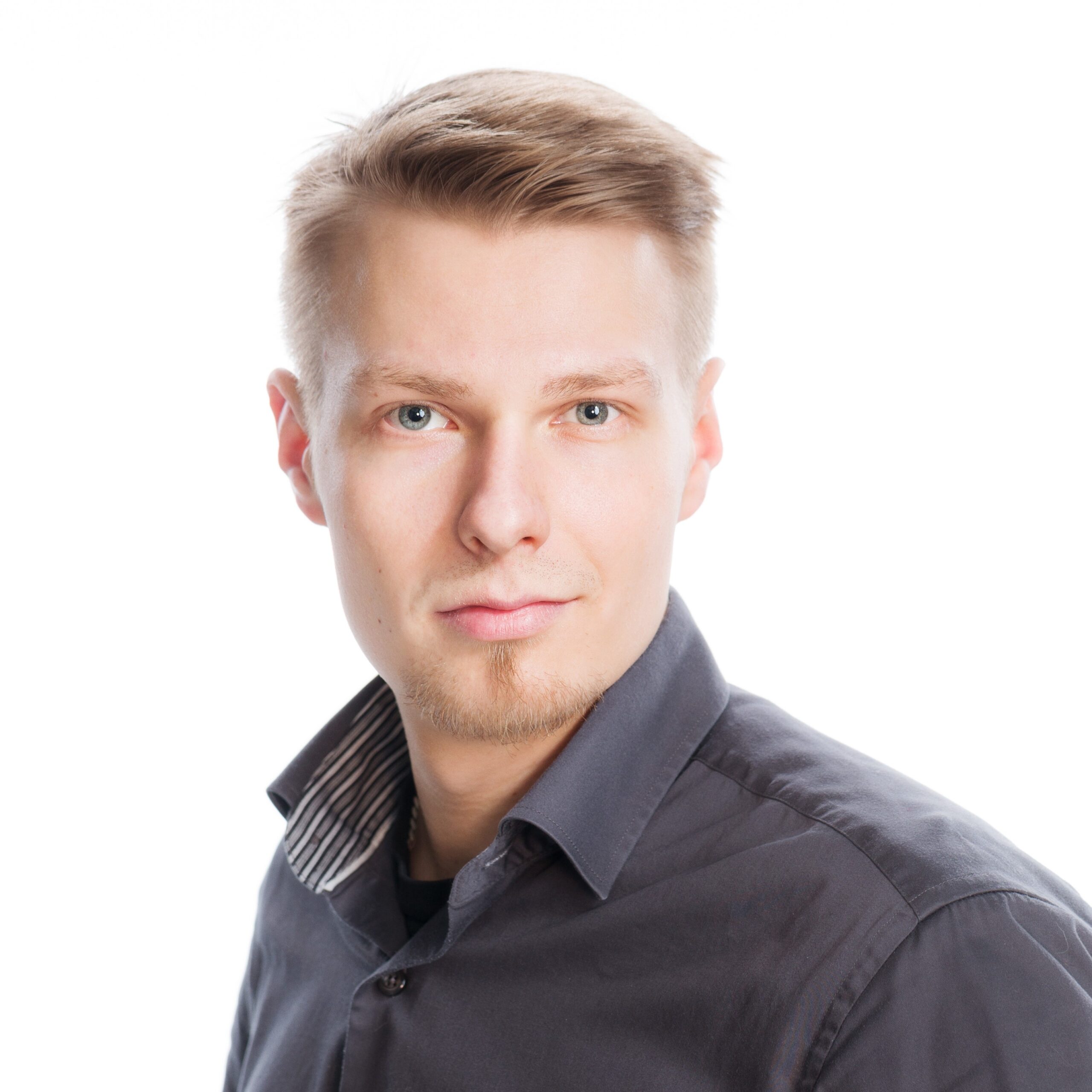 A man looks at the camera and smiles.