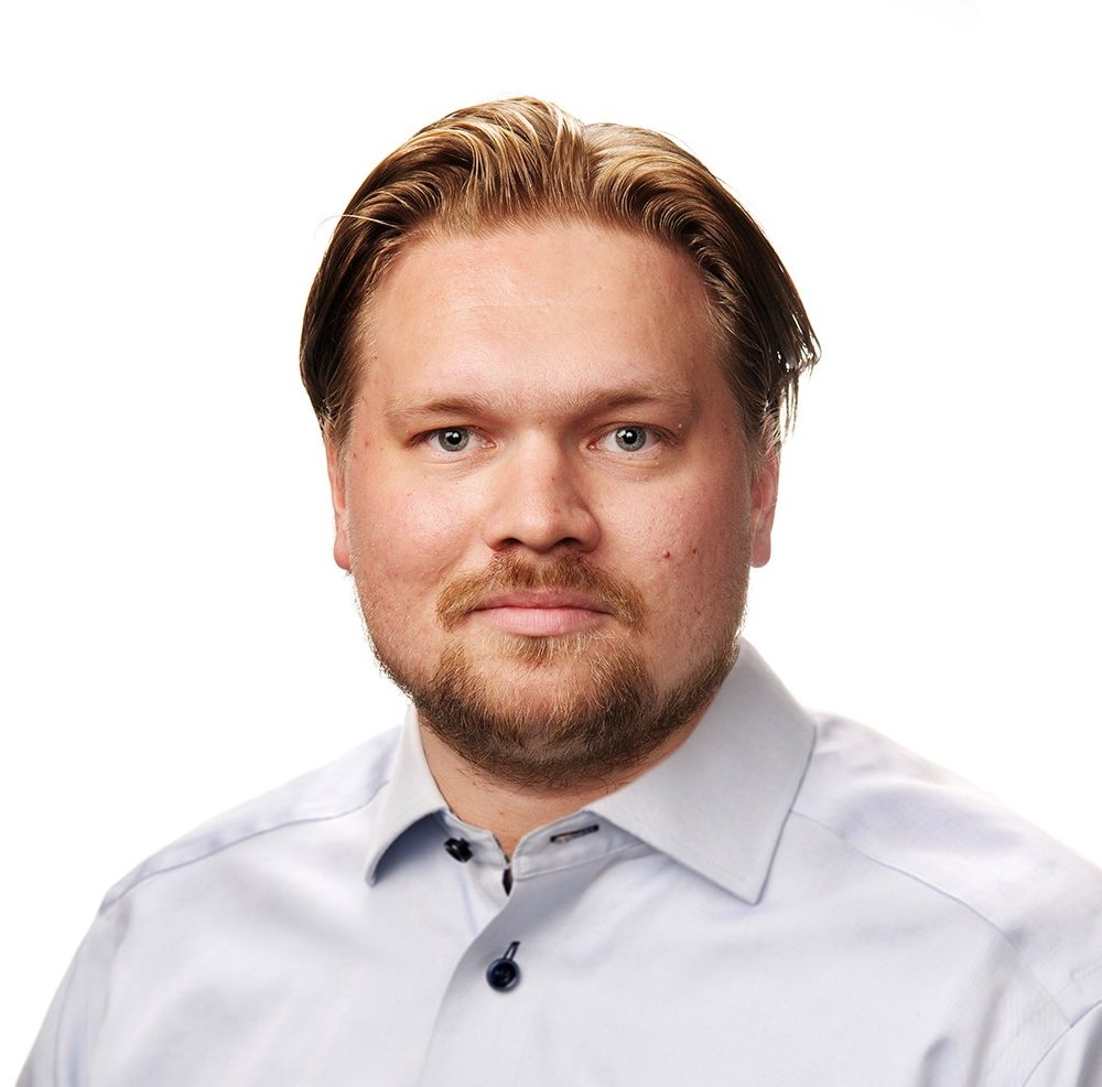 A man looks at the camera and smiles.
