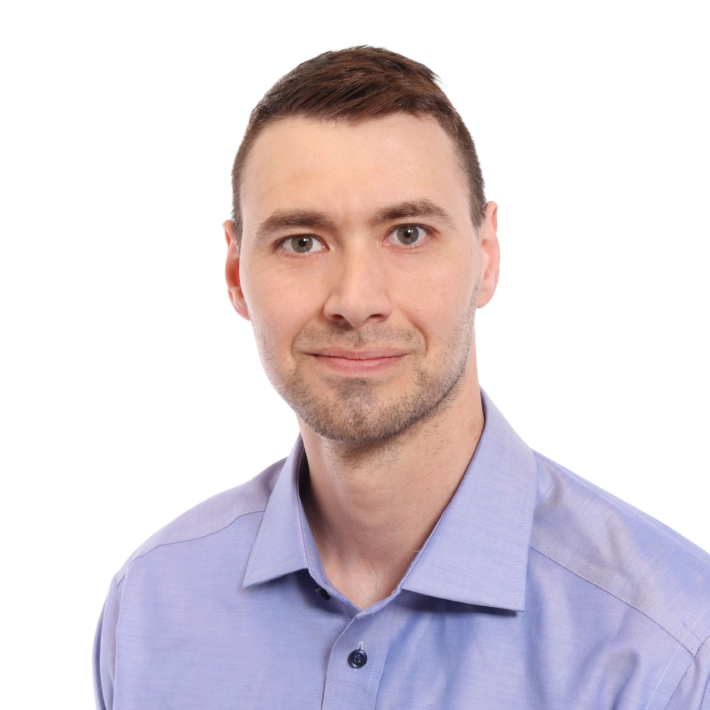 A man looks at the camera and smiles.
