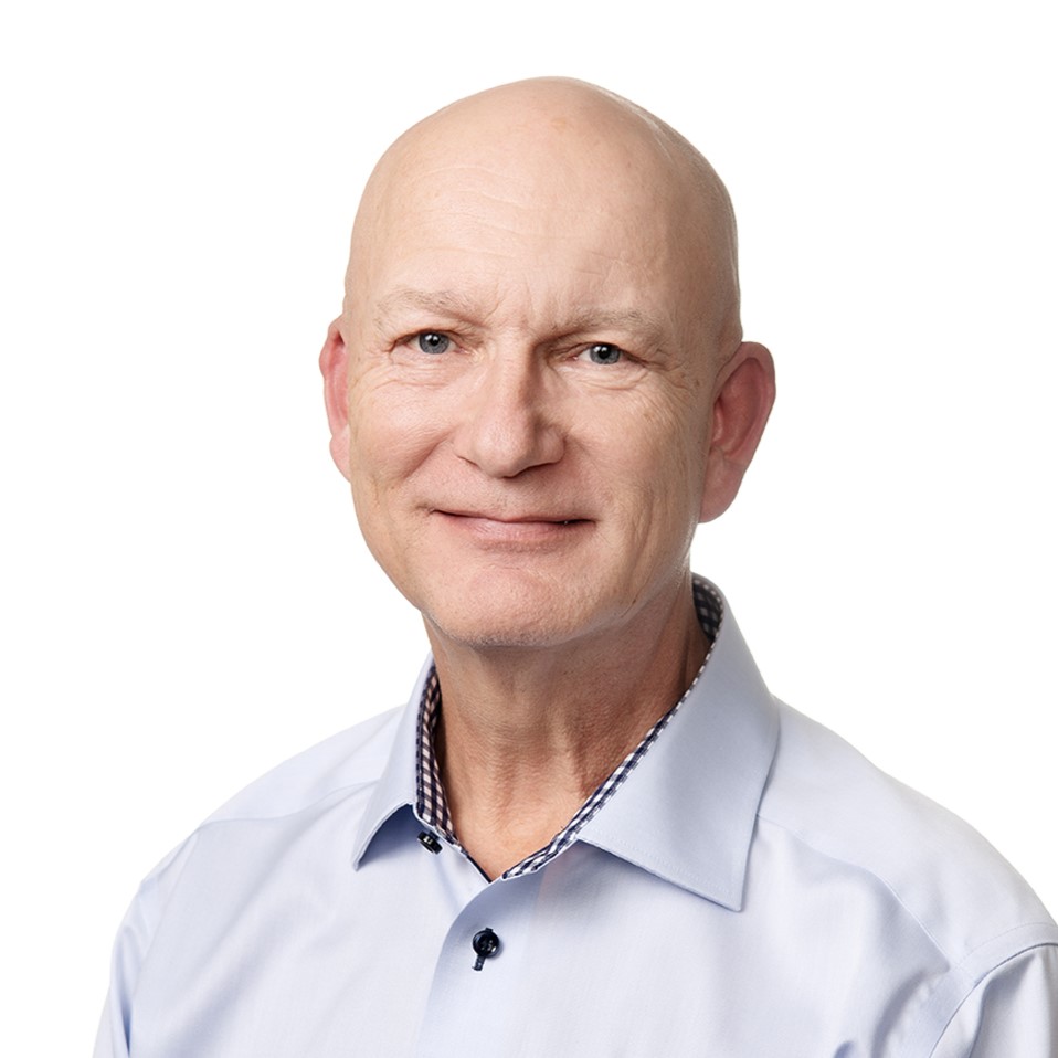 A man looks at the camera and smiles.