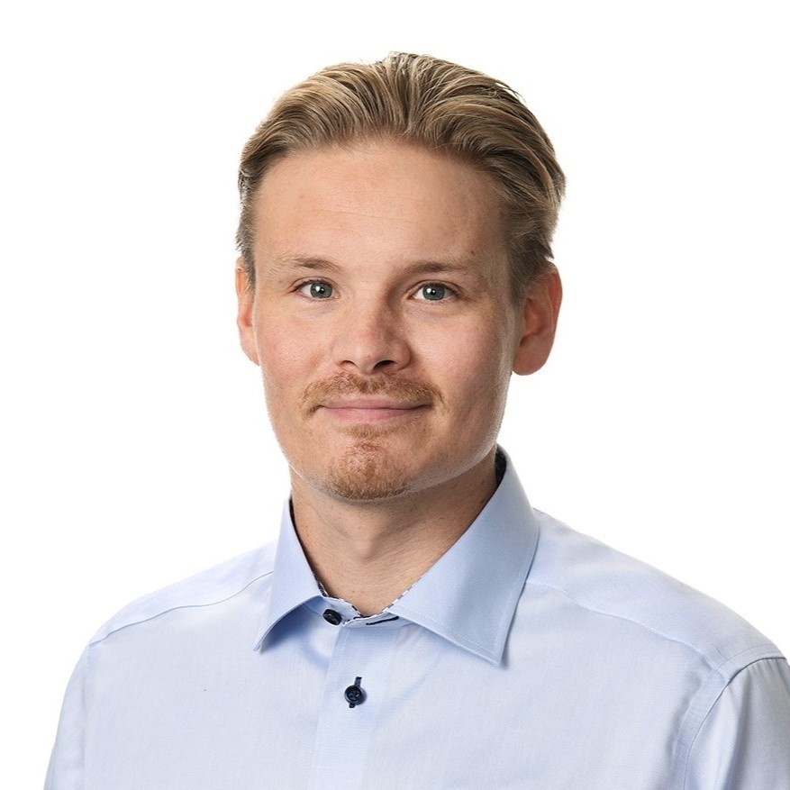 A man looks at the camera and smiles.